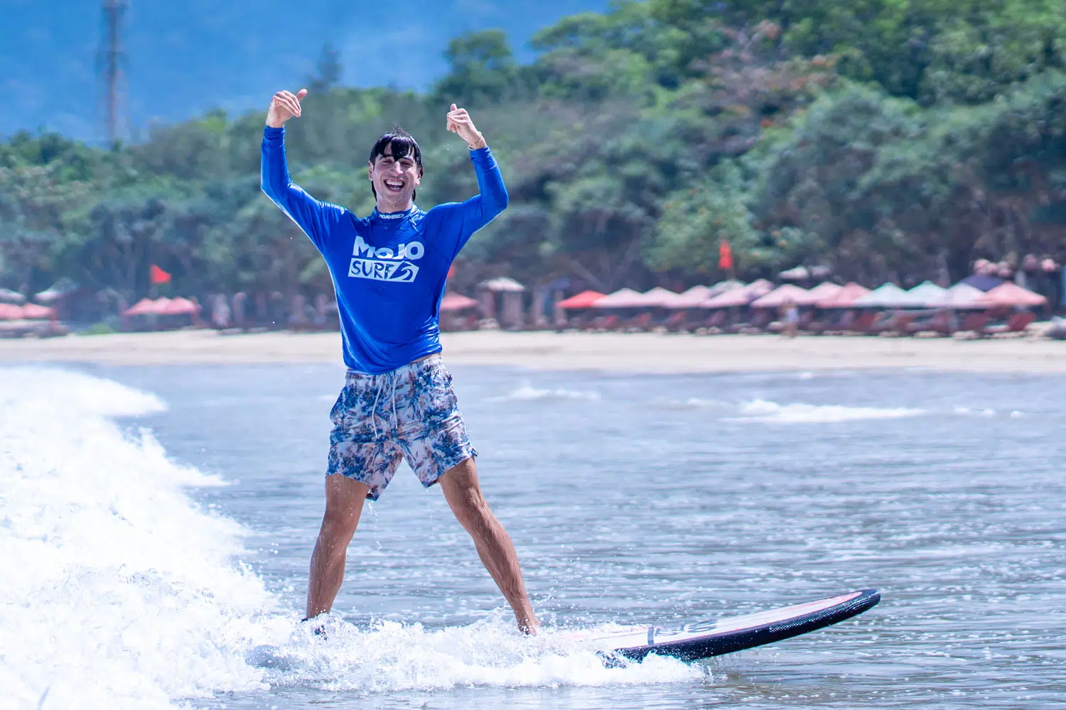 Surfer celebrating on a wave at Red Island