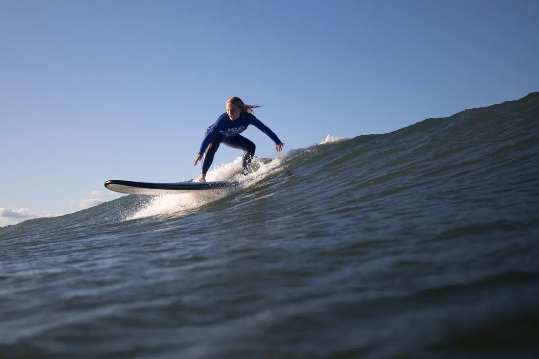 Surfer riding a wave during a lesson