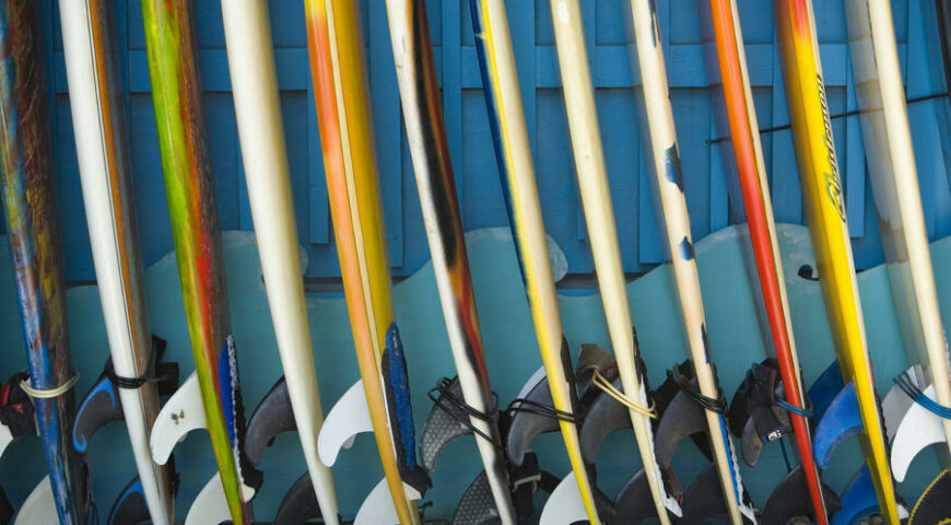 Row Of Surfboards Lined Up Against A Wall.