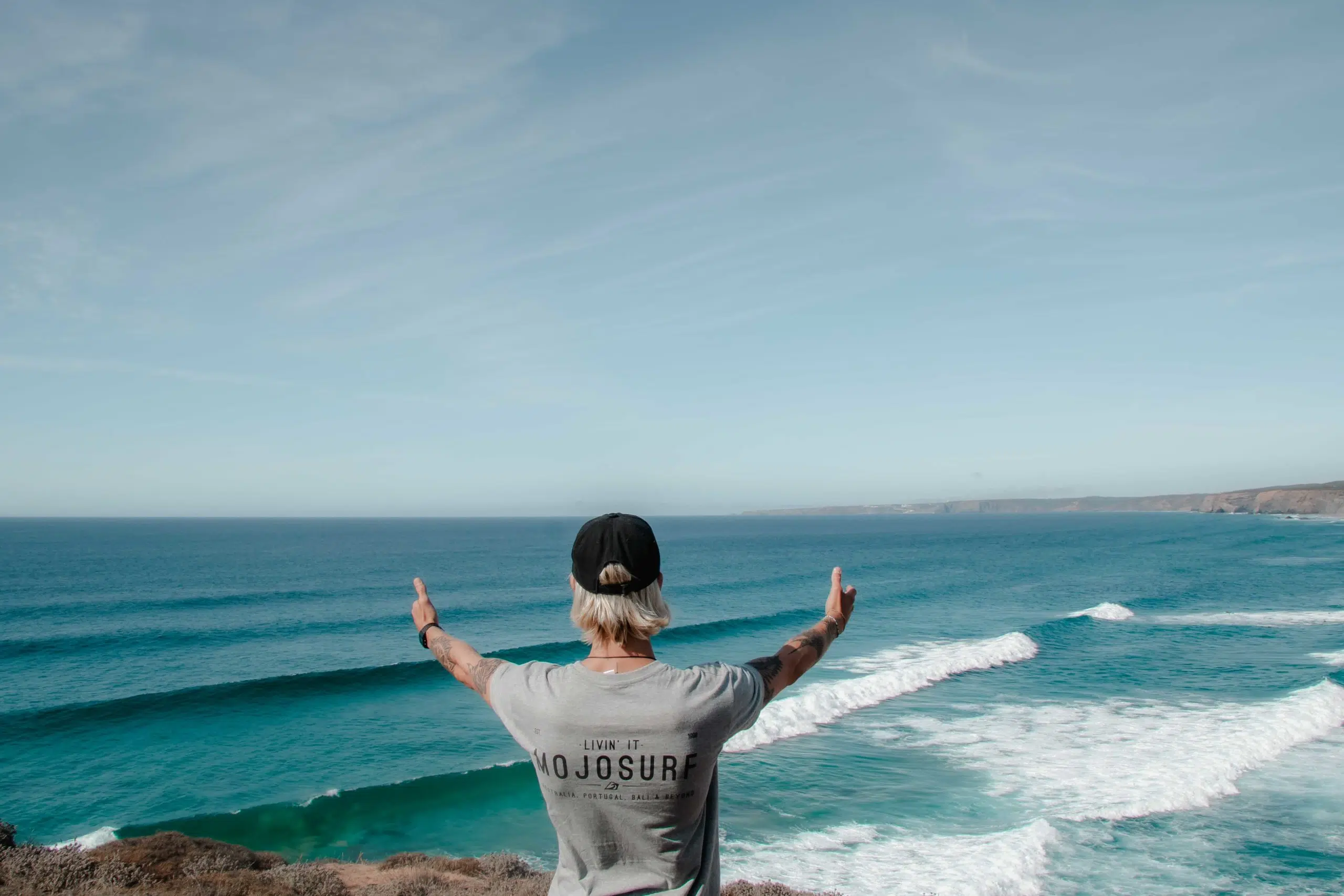 Surfer celebrating with arms raised in the ocean