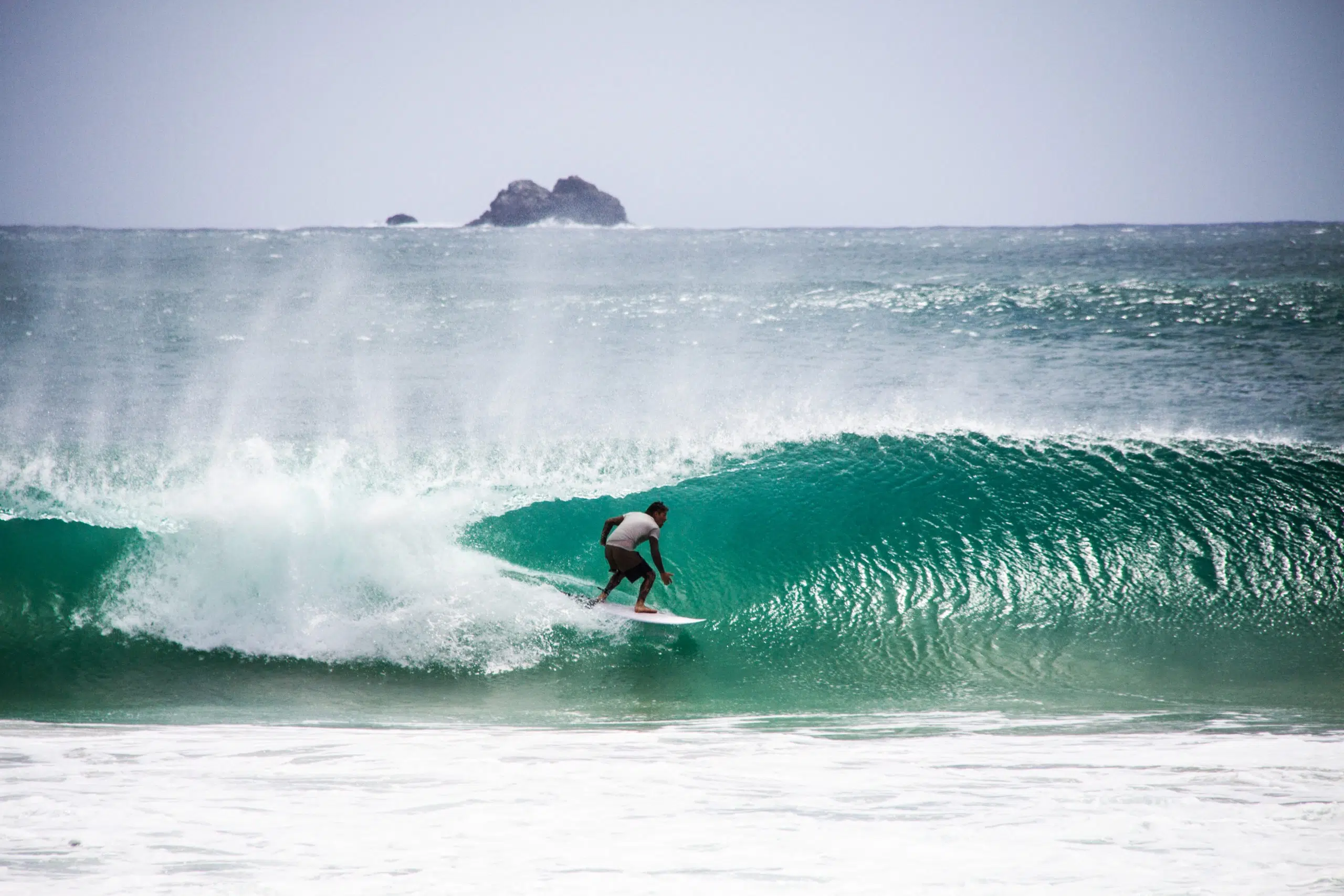Surfer inside a barrelling wave