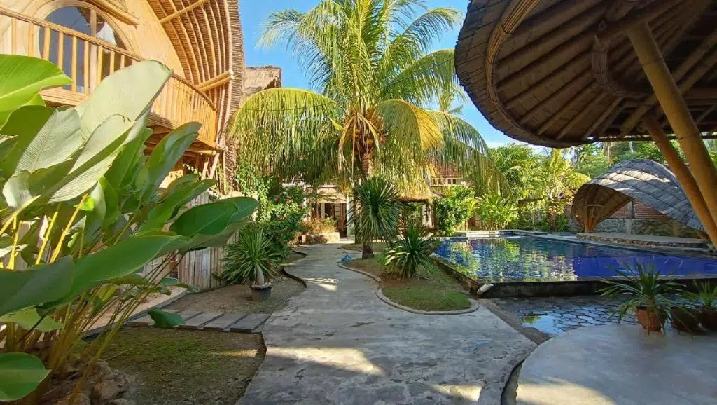 Tropical garden and pool at the Mojosurf camp in Lombok