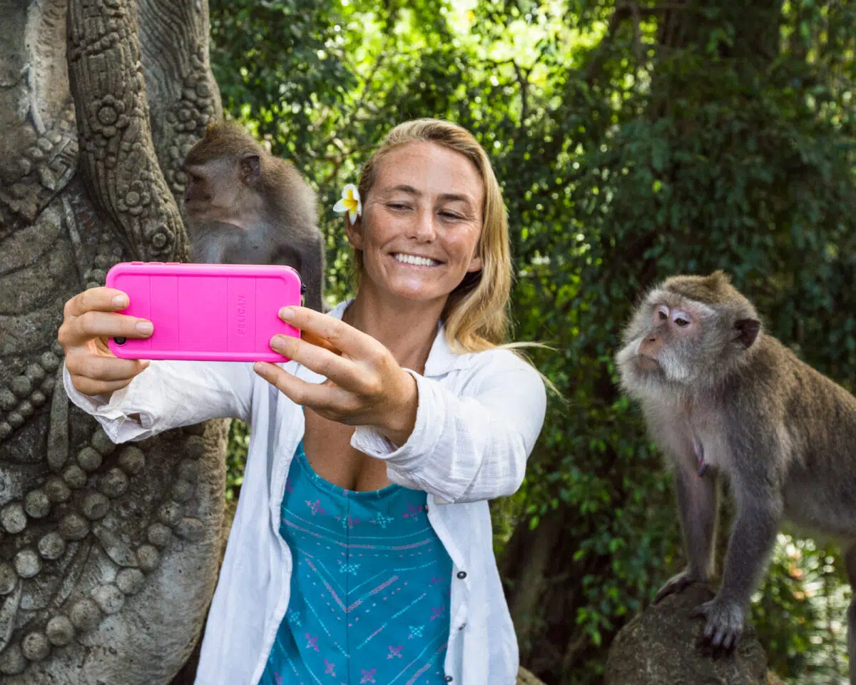 Guest taking a selfie with monkeys in Ubud, Bali