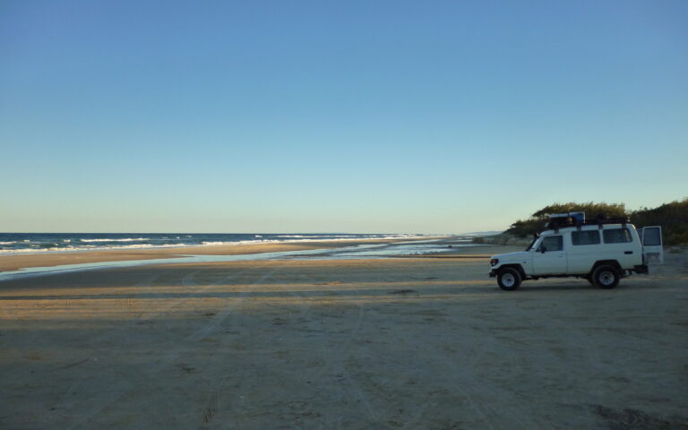 4WD parked on the beach at sunrise on Fraser Island (K'gari)