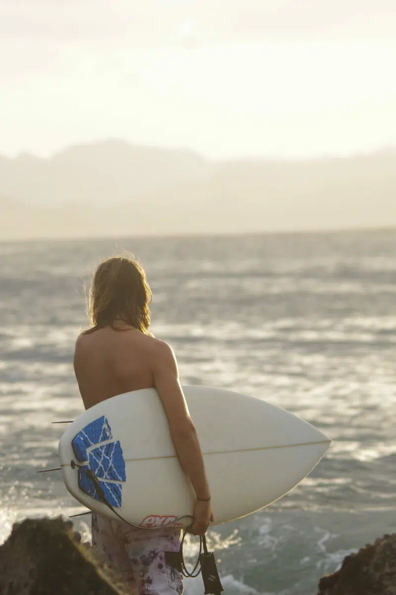 Surfer heading into the water in Bali