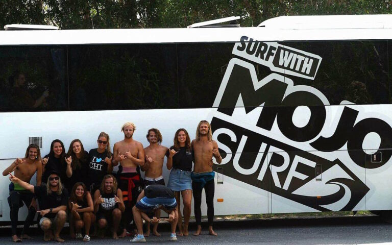 Mojosurf group in front of the Mojosurf bus