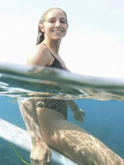 Surfer paddling out, half above and half below the water