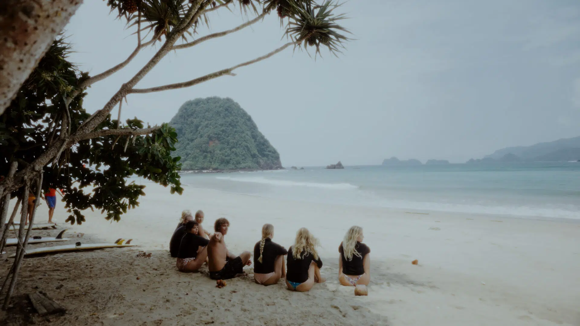 Friends relaxing on the beach at Red Island, Java