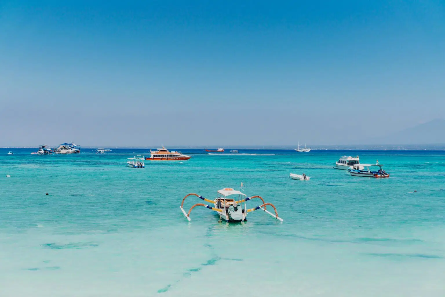 Traditional boats on turquoise water in Bali