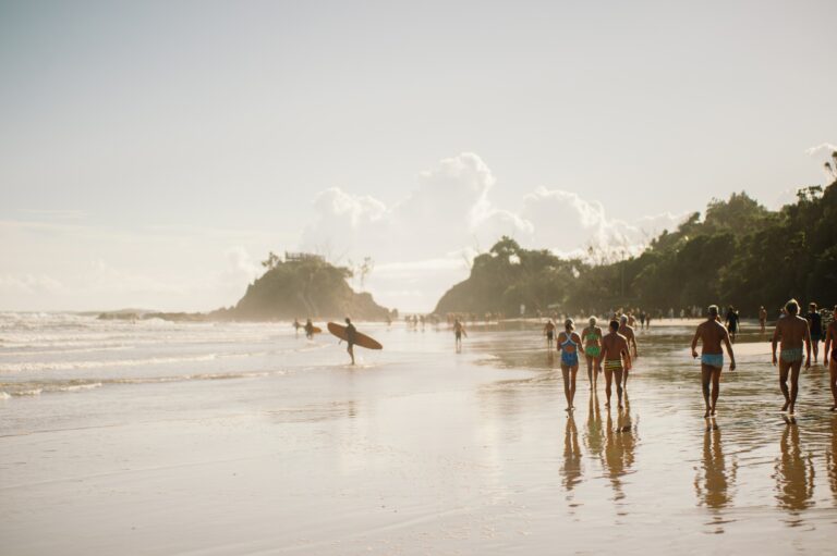 Surfers on the beach at sunrise in Byron Bay
