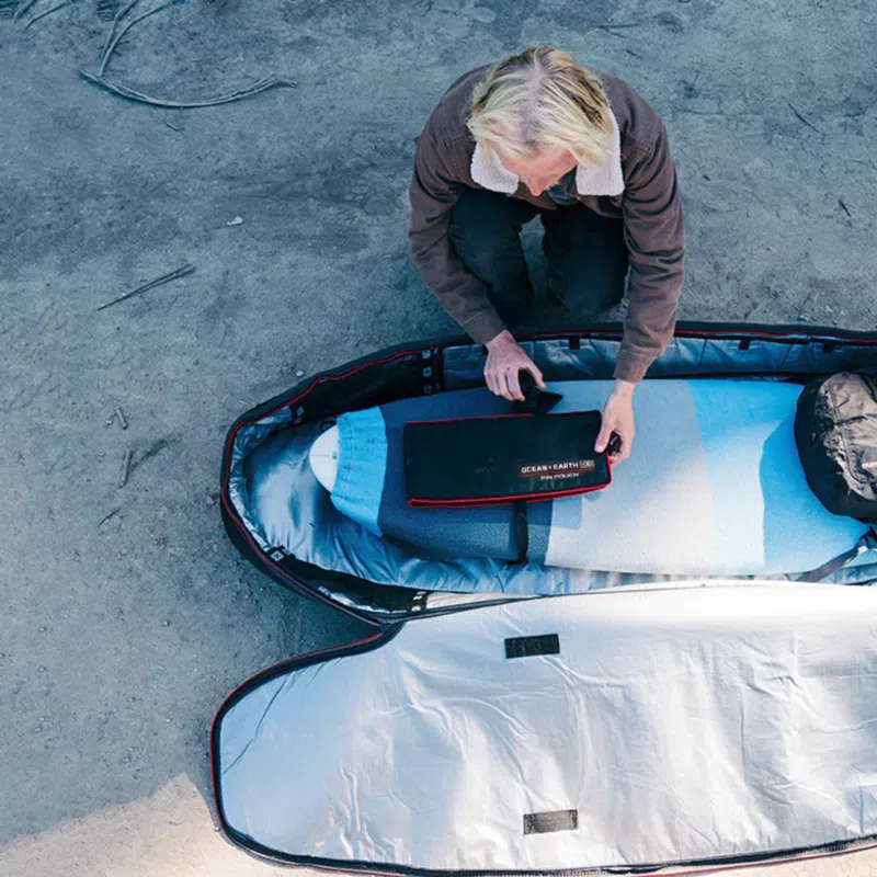 Packing a surfboard into a board bag