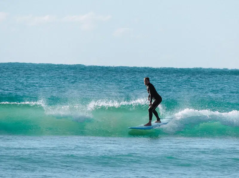 Surfer riding a green wave