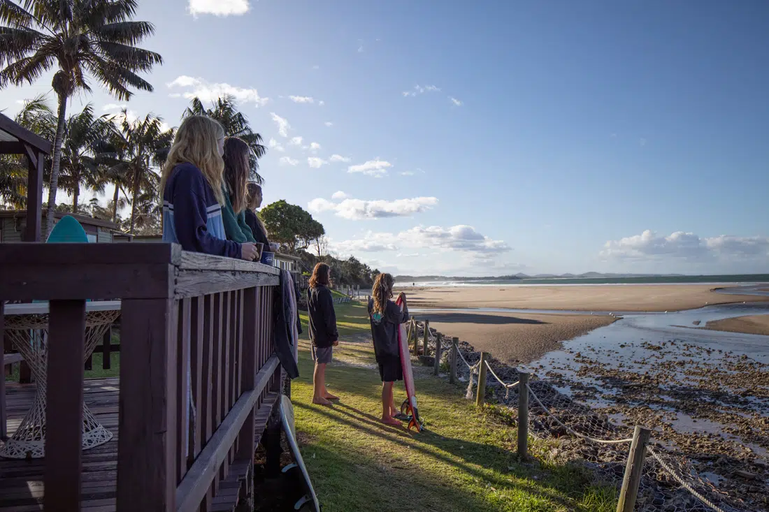Guests on a balcony overlooking the beach at Spot X