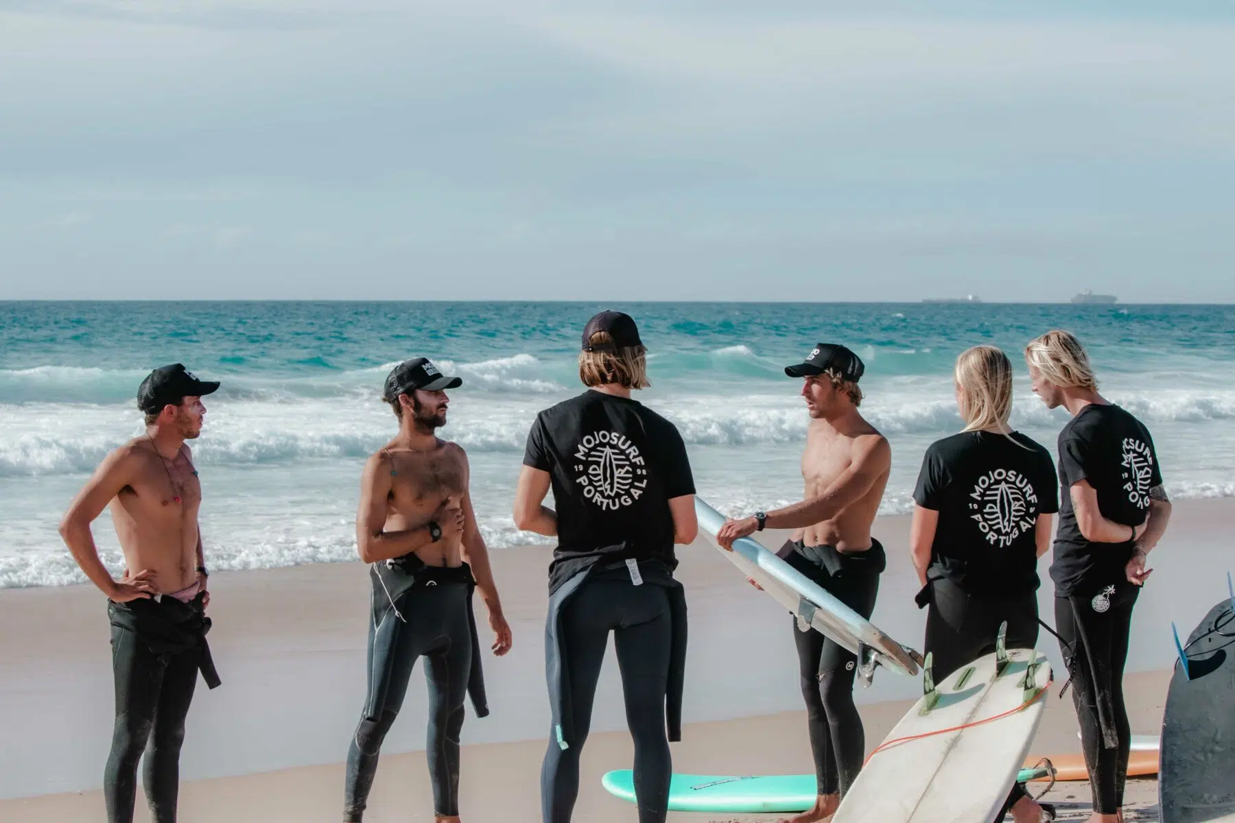Surf instructors and guests on the beach in Ericeira