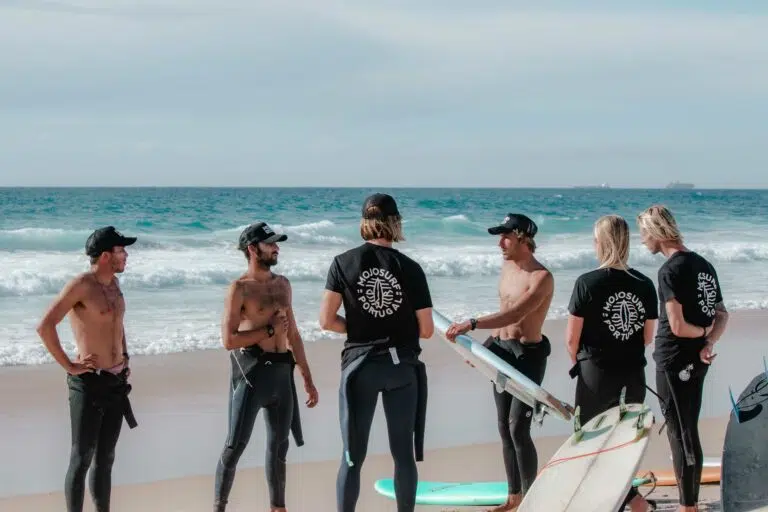 Surf instructors and guests on the beach in Ericeira
