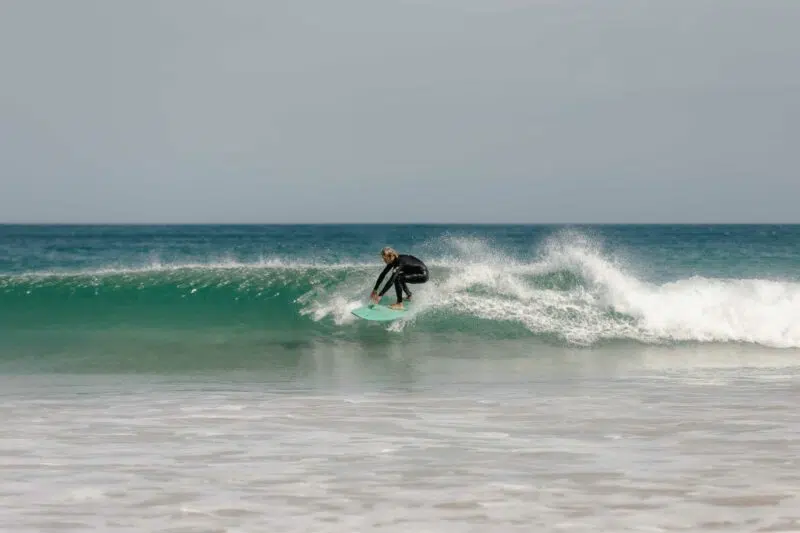 Surfer riding a wave in Peniche, Portugal