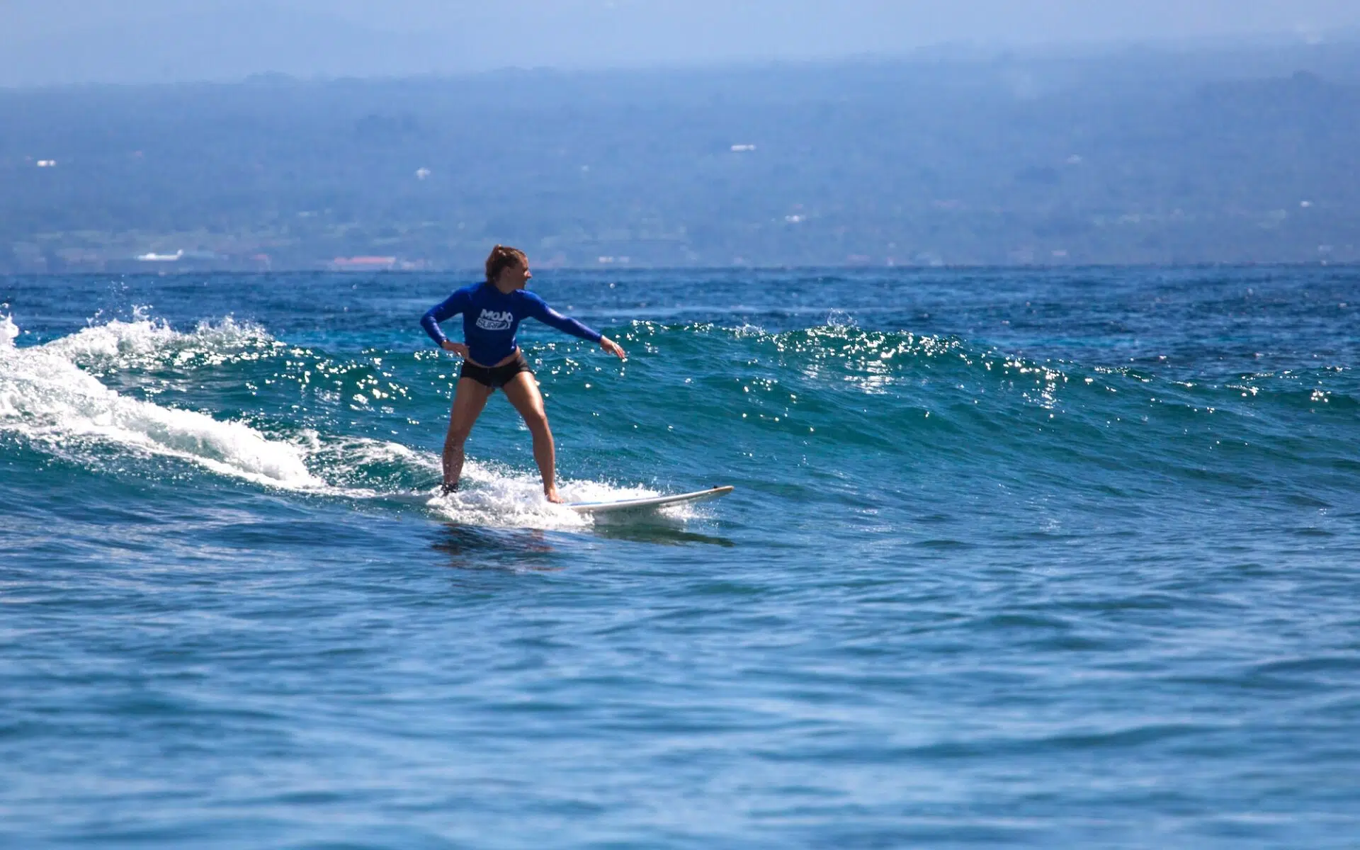 Surfer riding a wave at Nusa Lembongan