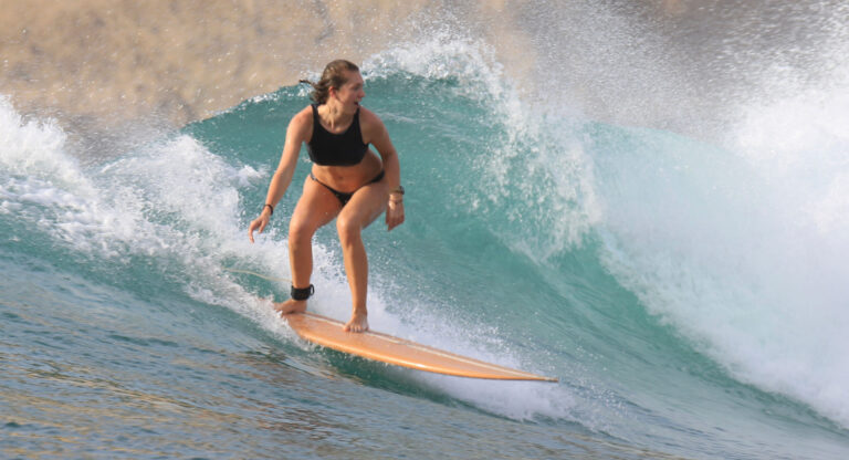 Surfer riding a wave in Lombok