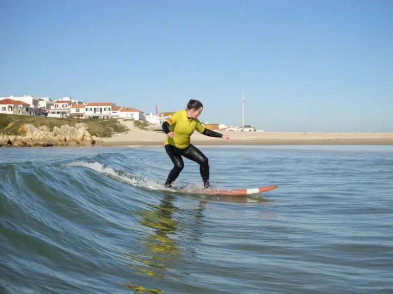 Surfer riding a wave at Baleal beach near Peniche