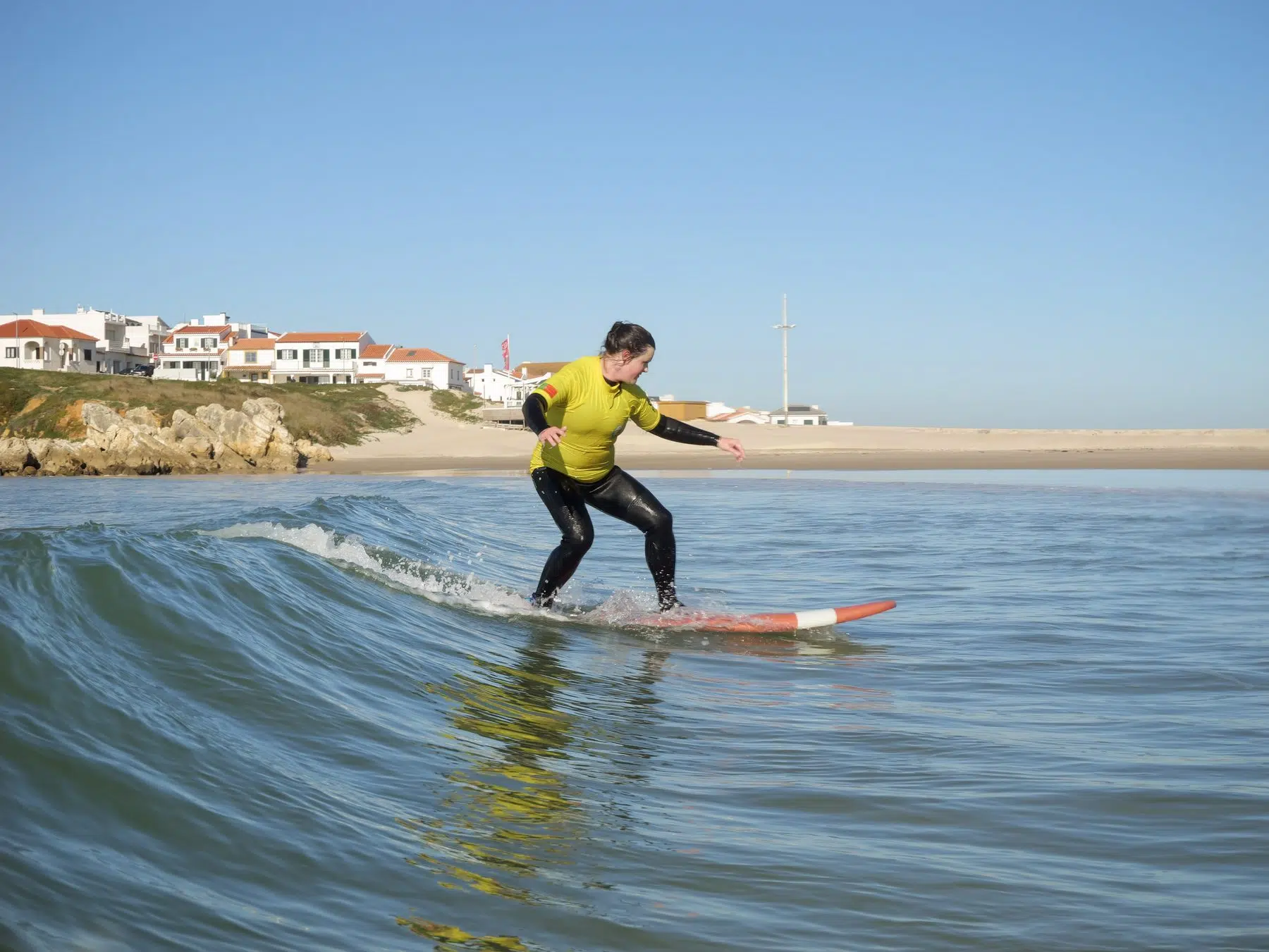 Surfer riding a wave at Baleal beach near Peniche