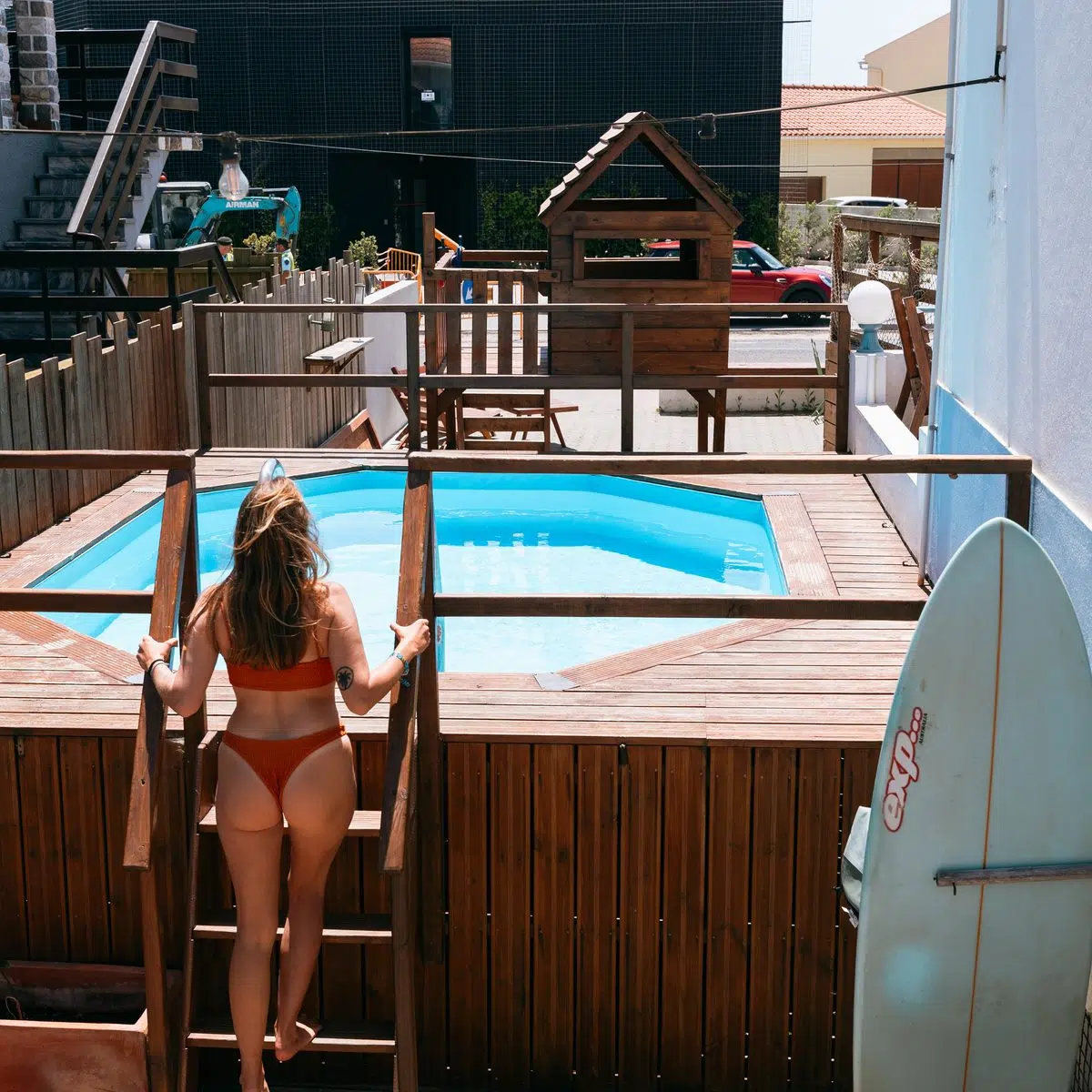 Guests by the pool deck at the Mojosurf hostel in Baleal